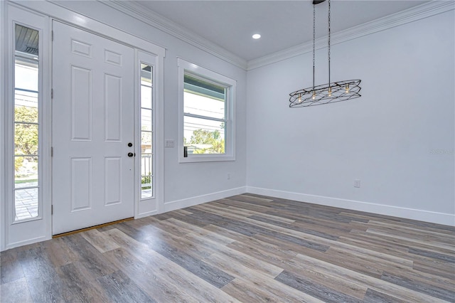 entryway with hardwood / wood-style floors and crown molding