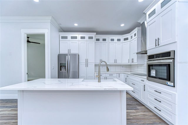 kitchen featuring a center island with sink, white cabinetry, and stainless steel appliances