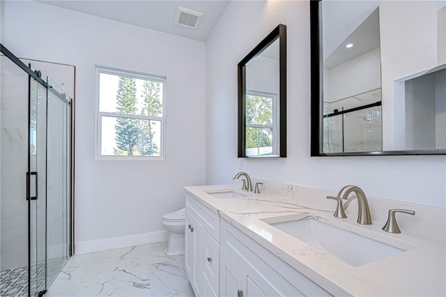 bathroom with vanity, an enclosed shower, and toilet