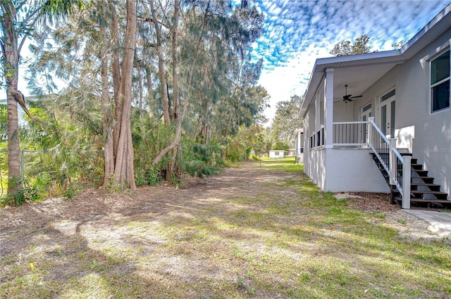 view of yard with ceiling fan