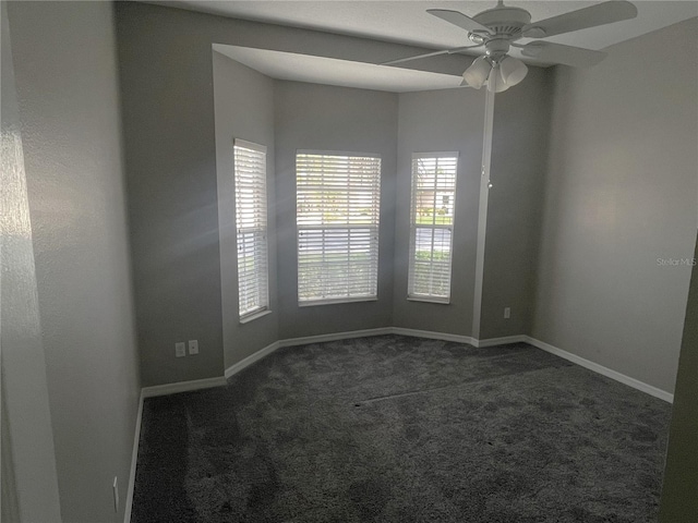 carpeted spare room featuring ceiling fan