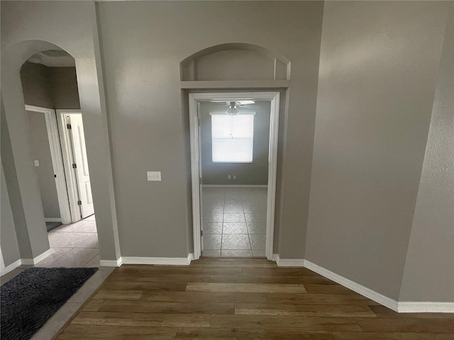 hallway with hardwood / wood-style flooring