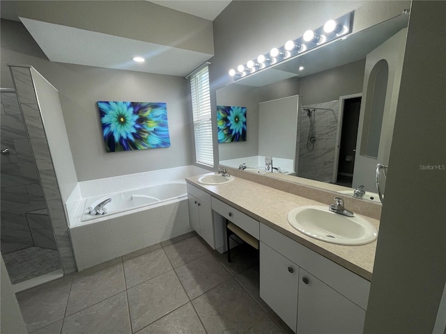 bathroom featuring plus walk in shower, vanity, and tile patterned floors