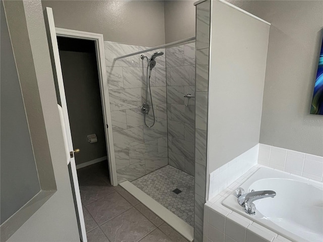 bathroom featuring separate shower and tub and tile patterned floors