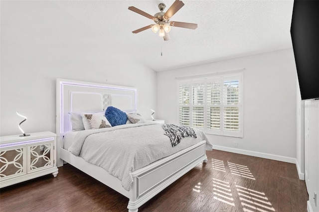 bedroom with a textured ceiling, dark hardwood / wood-style flooring, and ceiling fan