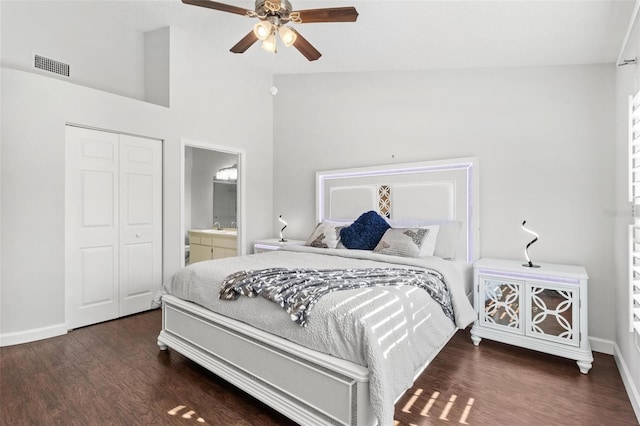 bedroom with dark wood-type flooring, high vaulted ceiling, ceiling fan, connected bathroom, and a closet