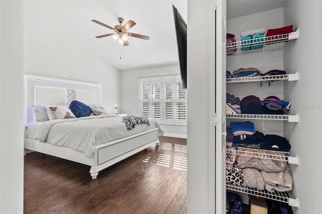 bedroom with a textured ceiling, ceiling fan, lofted ceiling, and hardwood / wood-style flooring