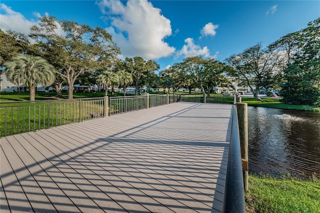 view of property's community featuring a water view and a lawn