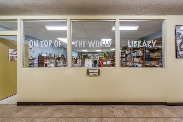 interior space with light tile patterned flooring and a textured ceiling