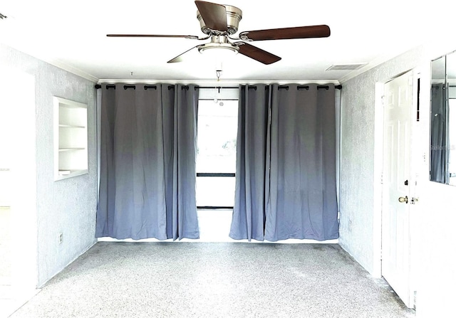 spare room featuring ceiling fan and built in features