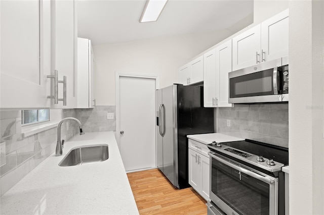 kitchen featuring white cabinetry, sink, and stainless steel appliances