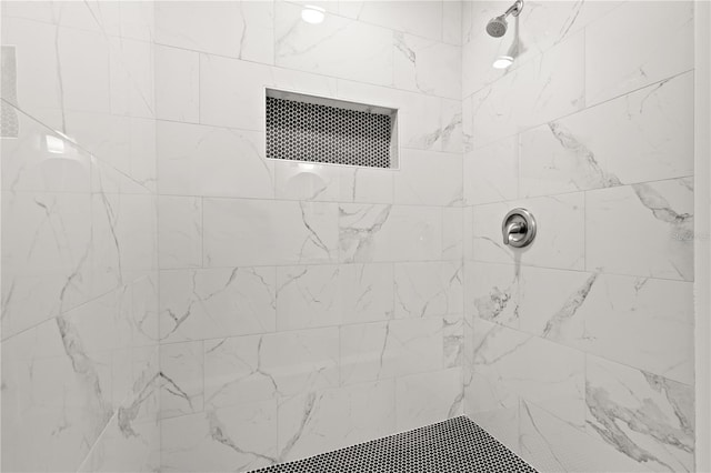 bathroom with tiled shower