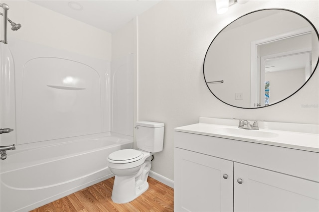 full bathroom featuring vanity, hardwood / wood-style floors,  shower combination, and toilet