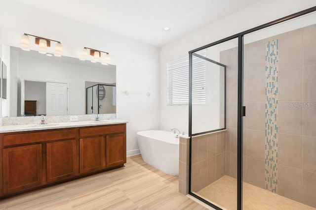 bathroom with separate shower and tub and vanity