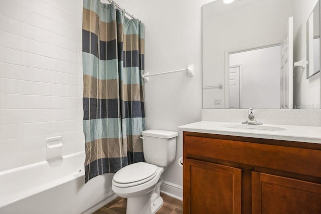 full bathroom featuring hardwood / wood-style floors, vanity, shower / tub combo, and toilet