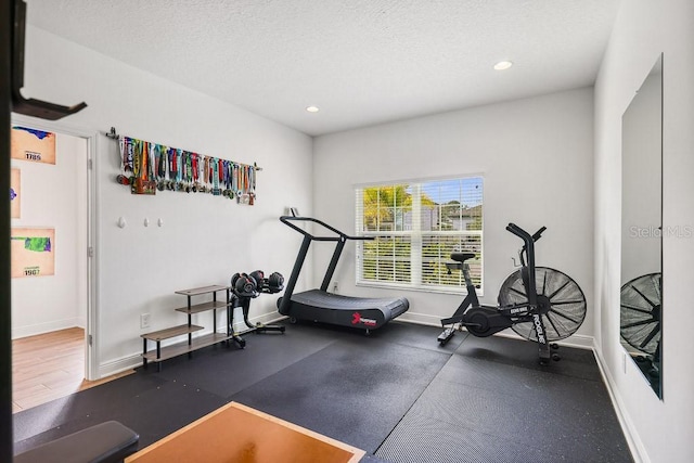 exercise room with a textured ceiling