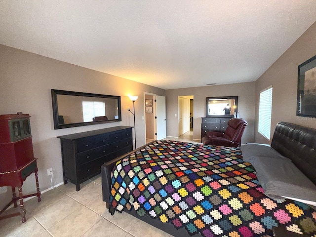 bedroom featuring light tile patterned flooring and a textured ceiling