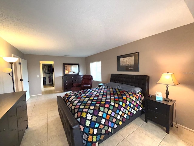 tiled bedroom featuring a textured ceiling