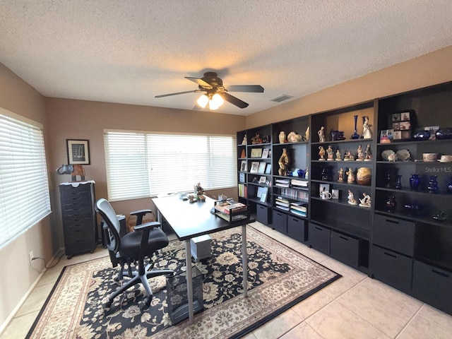 office with light tile patterned floors, a textured ceiling, and ceiling fan