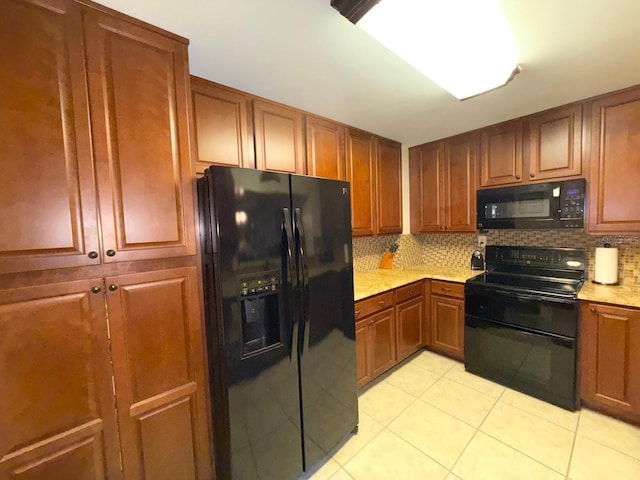 kitchen featuring black appliances, decorative backsplash, and light tile patterned floors