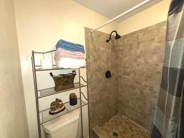 bathroom with curtained shower and toilet