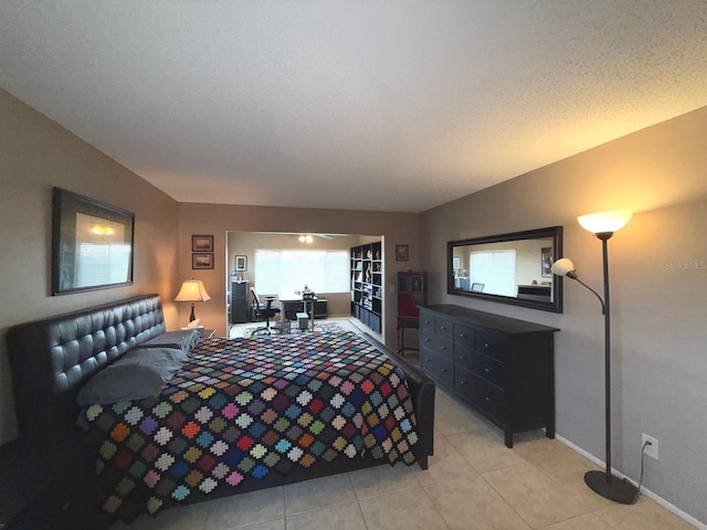 bedroom with light tile patterned floors and a textured ceiling