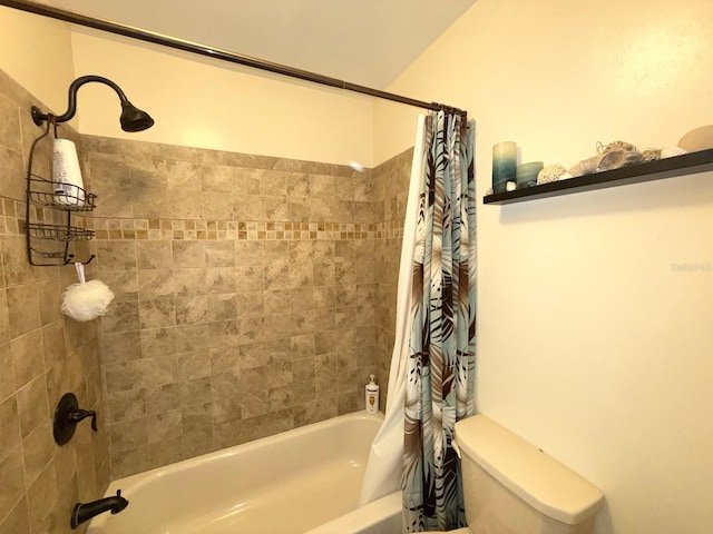 bathroom featuring shower / bath combination with curtain and toilet