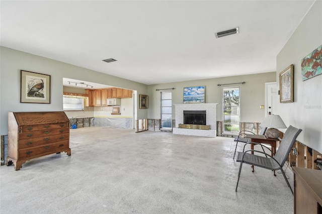 living room featuring a brick fireplace