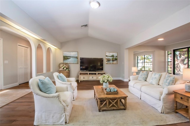 living room featuring hardwood / wood-style floors and vaulted ceiling