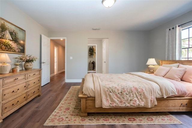 bedroom with dark wood-type flooring