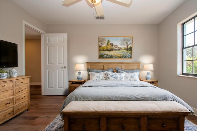 bedroom with ceiling fan and dark hardwood / wood-style floors