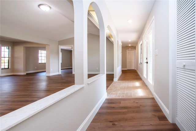 hallway featuring hardwood / wood-style floors and lofted ceiling