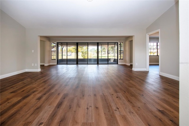 empty room featuring dark hardwood / wood-style floors and lofted ceiling