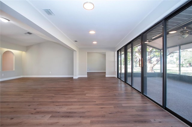 unfurnished room with dark hardwood / wood-style floors, ceiling fan, and ornamental molding