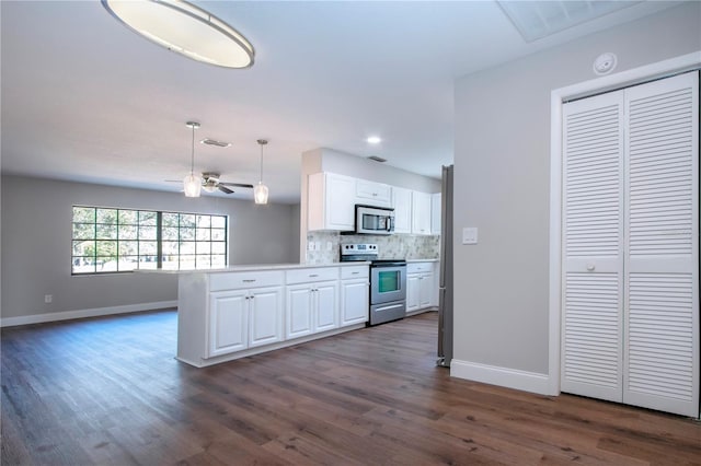 kitchen featuring kitchen peninsula, decorative backsplash, stainless steel appliances, pendant lighting, and white cabinetry