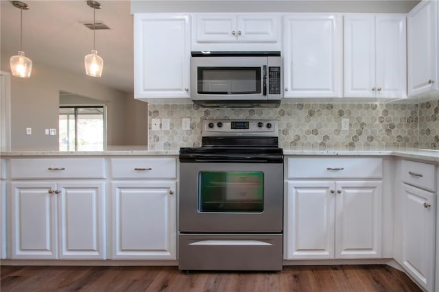 kitchen with white cabinets, appliances with stainless steel finishes, and decorative backsplash