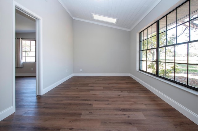 empty room featuring wooden ceiling, vaulted ceiling, dark wood-type flooring, and crown molding