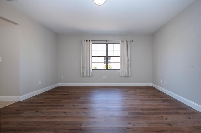 spare room with dark hardwood / wood-style flooring