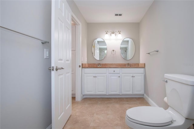 bathroom with tile patterned floors, vanity, and toilet