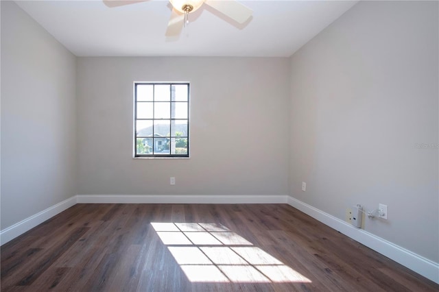 empty room with ceiling fan and dark hardwood / wood-style flooring