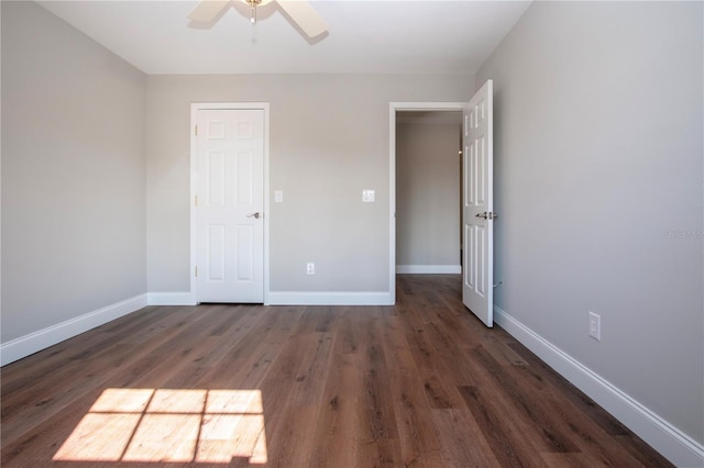 unfurnished bedroom featuring ceiling fan, dark wood-type flooring, and a closet