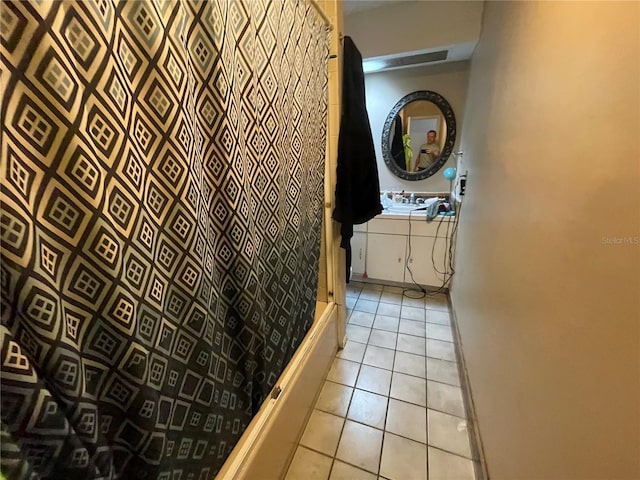 hall featuring light tile patterned flooring