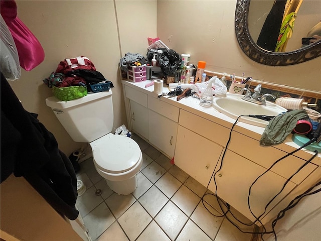 bathroom featuring tile patterned floors, vanity, and toilet