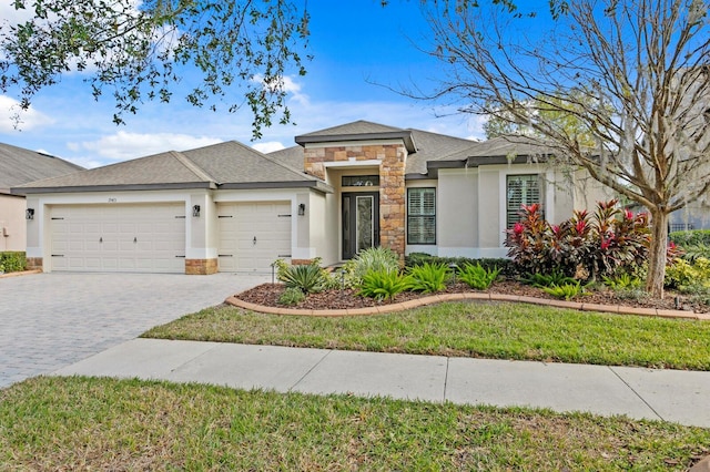 view of front of house with a front yard and a garage