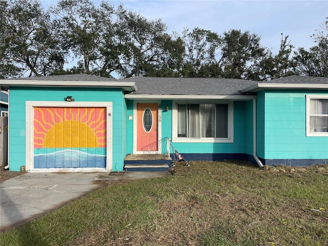 ranch-style home with a garage and a front lawn