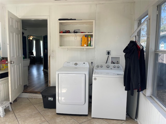 clothes washing area featuring separate washer and dryer and light tile patterned floors