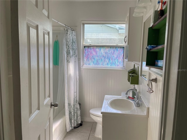 full bathroom with shower / tub combo with curtain, tile patterned floors, toilet, and vanity