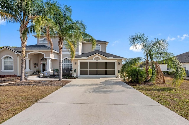 view of front of property featuring a garage and a front yard