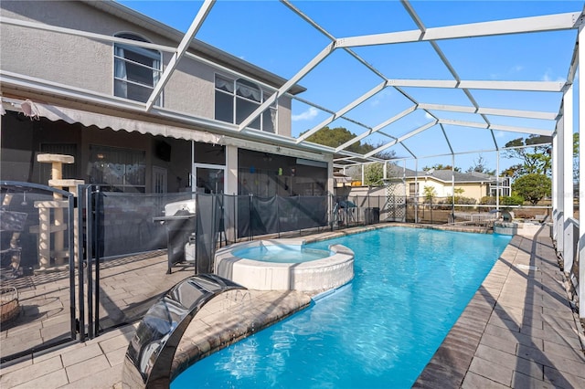 view of swimming pool featuring an in ground hot tub, a patio, and glass enclosure