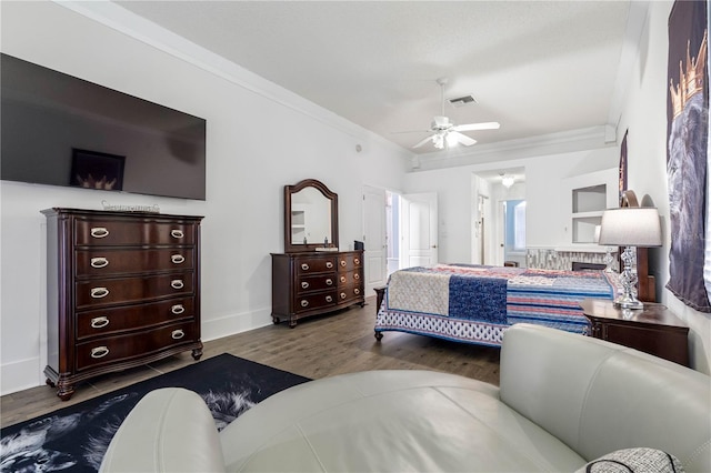 bedroom featuring ornamental molding, wood-type flooring, and ceiling fan